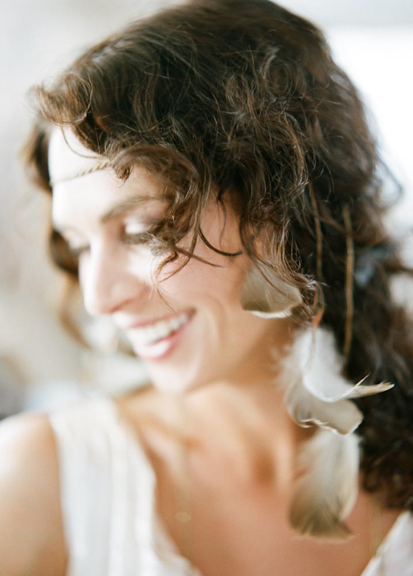 Laughing bride portrait with feather accessories - wedding photo by top Austin based wedding photographers Q Weddings